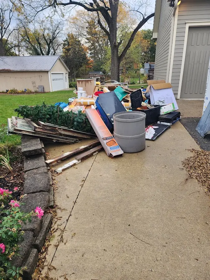 Dumpster being loaded with debris for Estate Cleanout Dumpster Rental in Fort Washington